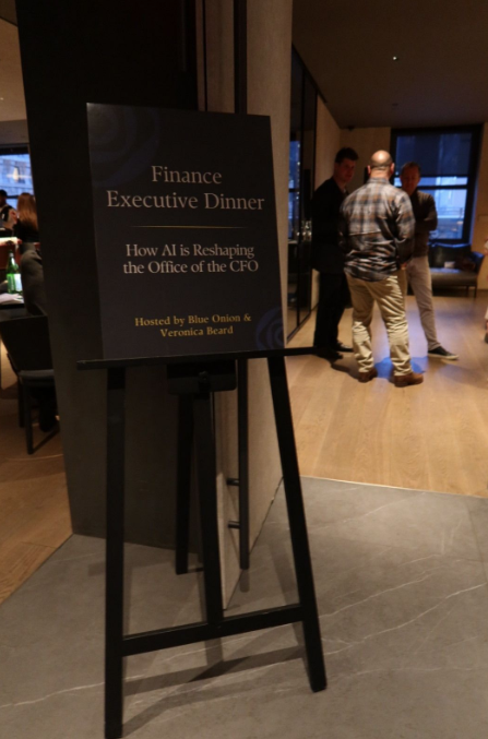 Finance Executive Dinner sign — 'How AI is Reshaping the Office of the CFO', hosted by Blue Onion & Veronica Beard